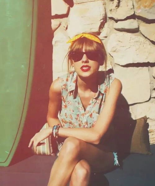 a woman sitting next to a green surfboard