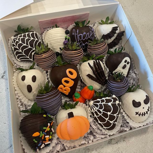 a box filled with halloween chocolate covered strawberries