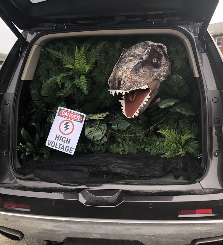 an image of a dinosaur head in the back of a car