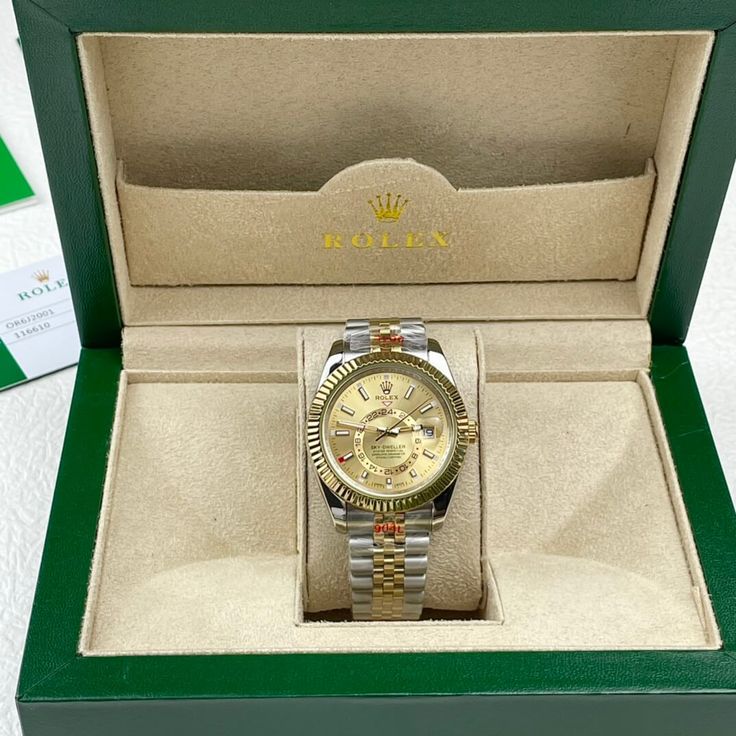 This timepiece is a Rolex Sky-Dweller, distinguished by its two-tone Oystersteel and 18ct yellow gold construction. The champagne dial features the iconic off-center 24-hour disc for dual time zone display, and an annual calendar. The watch is powered by the Calibre 9001, a complex self-winding mechanical movement. The fluted bezel, Oyster bracelet with Easylink extension, and Superlative Chronometer certification exemplify Rolex's commitment to precision and luxury. This Sky-Dweller is a sophis Gold Diamond Chronometer Watch For Business, Gold Diamond Watch With Chronometer For Business, Classic Diamond Watch With Day-date Display, Gold Diamond Watch With Subdials For Business, Gold Diamond Business Watch, Gold Diamond Watch For Business, Gold Diamond Watch With Round Dial For Business, Gold Automatic Round Watch Accessory, Gold Automatic Watch Accessories