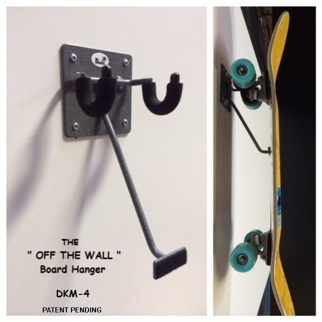 a skateboard mounted to the side of a wall with an upside down hook on it