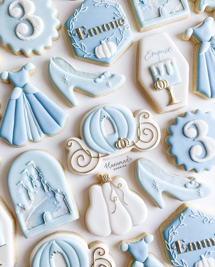 blue and white baby shower cookies on a table