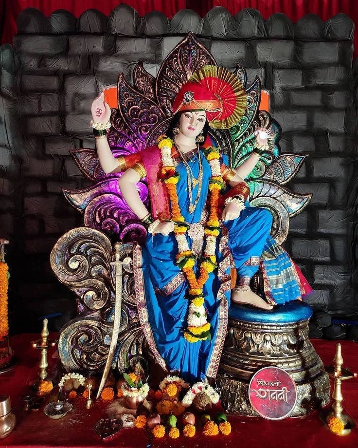 a statue of the hindu god sitting on a throne