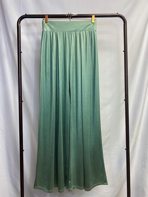 Silky SeafoamGreen Pants Like the smooth waves of the sea washing over the sand. Flow into the room with elegance in these silky mermaid-like pants. These pants are made with a silky, heavy fabric which creates a shimmery drape effect. The legs are flared and create a sleek look. The wide waistband is elastic and the fabric is also stretchy, for a flexible fit. Pleated at the front and the back. Model is 5'2" in 3-inch heels, wearing a size small. Chic Green Satin Bottoms, Stretch Satin Bottoms For Summer, Green Straight Pants For Evening, Party Stretch Satin Bottoms, Stretch Satin Bottoms For Night Out, Elegant Green Wide Leg Pants With Elastic Waistband, Evening Green Trousers, Summer Full-length Satin Pants, Summer Satin Full-length Pants