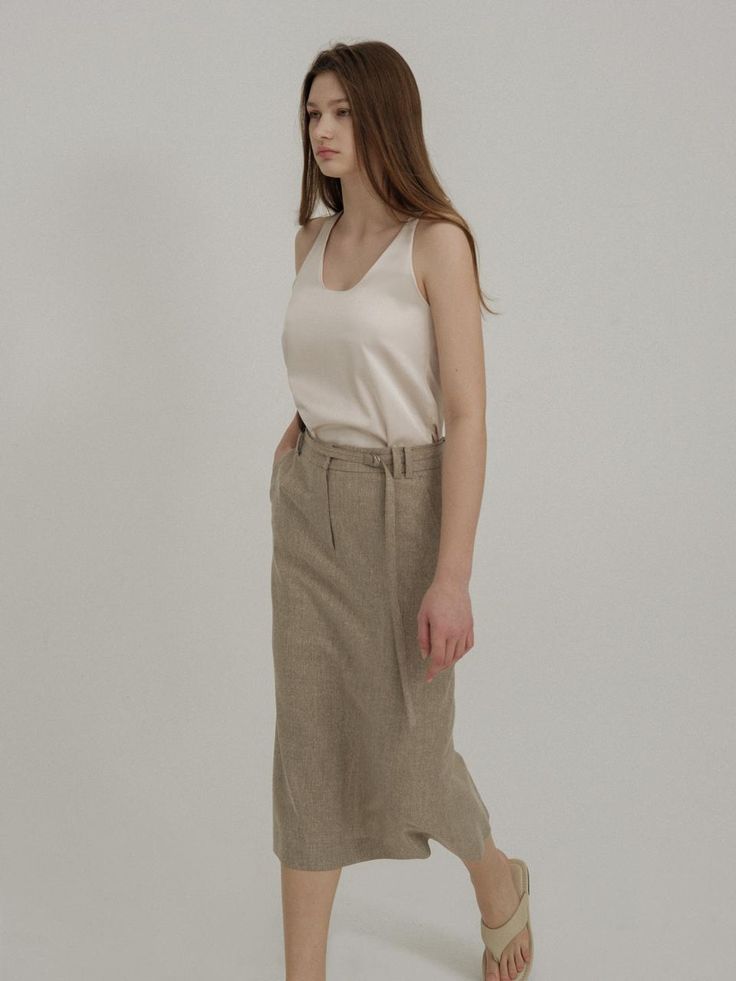 This is a trendy and minimal skirt by AVA MOLLI that is made out of high quality and sturdy material. With distinctive mood of the design and feminine look, you can style it for your trendy and casual daily outfit.- H line silhouette- Belt included with double belt loop- Set up with matching jacket Elegant Linen Pencil Skirt, Modern Long Pencil Skirt For Spring, Linen Midi Skirt For Work, Linen Lined Skirt For Workwear, Casual Neutral Midi Skirt, Modern Pencil Skirt For Summer, Linen Skirt For Workwear, Beige Asymmetrical Relaxed Skirt, Beige Long Workwear Skirt