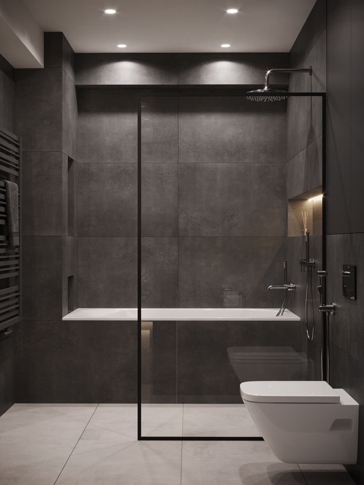 a bathroom with a toilet, sink and shower stall in the middle of it's walls