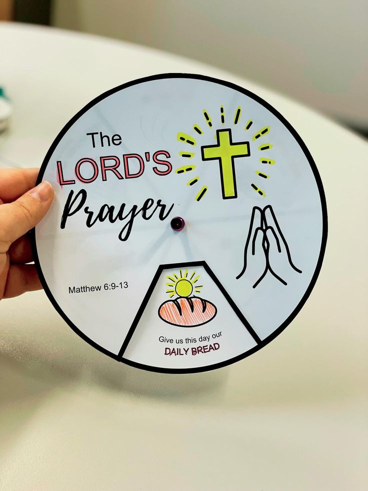 a person holding up a paper clock with the words, the lord's prayer