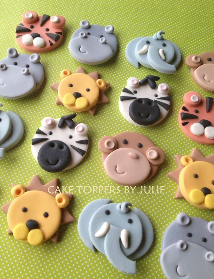 many decorated cookies are arranged in the shape of animals