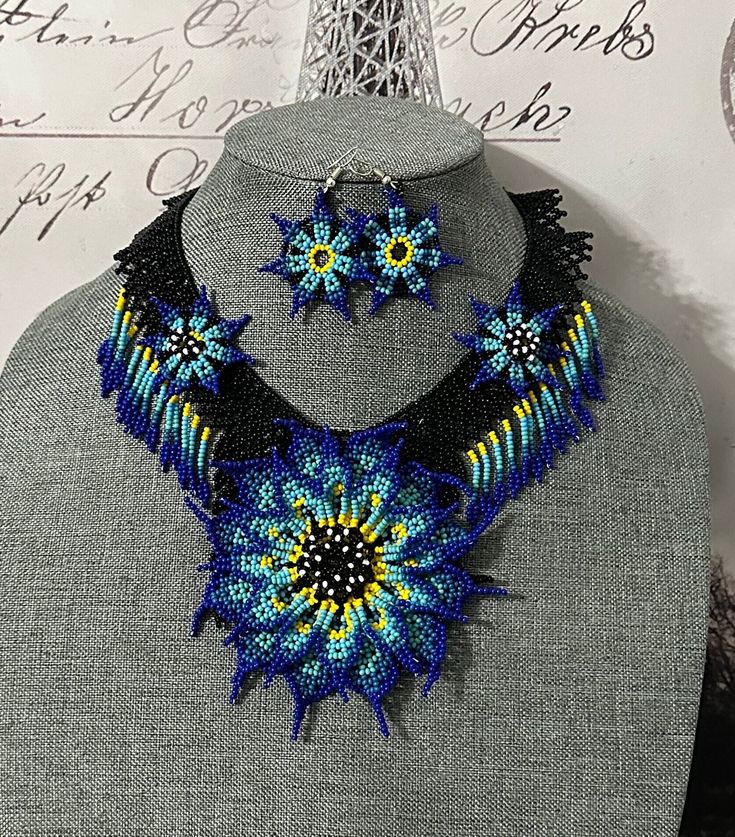 beautiful set of handmade necklace and earrings. Elisa model, handmade by Mexican artisans. 100% Mexican crafts Handmade Blue Flower Pendant Necklace, Handmade Pendant Jewelry Sets In Costume Style, Handmade Pendant Costume Jewelry Sets, Handmade Costume Jewelry Sets With Pendant, Artisan Bib Necklace With Large Beads As Gift, Bohemian Multicolor Necklace With Matching Earrings, Bohemian Multicolor Necklaces With Matching Earrings, Handmade Blue Jewelry Sets With Round Beads, Artisan Bib Necklace With Large Beads For Gifts