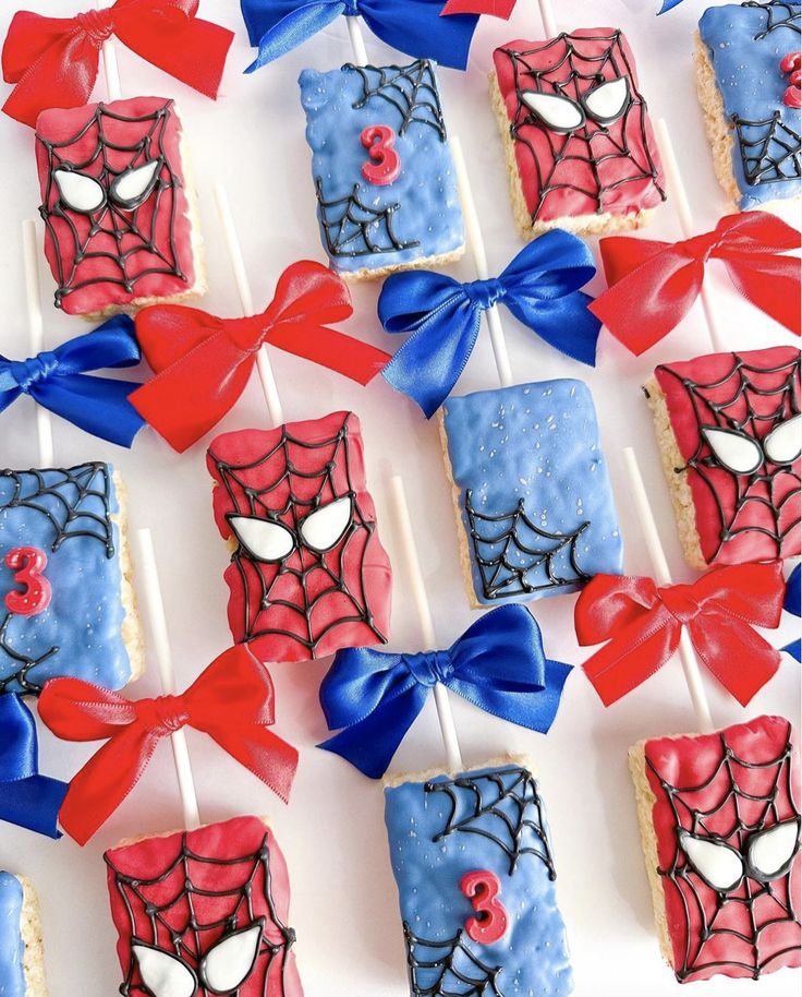 spiderman cake pops with red, white and blue frosting on them are ready to be eaten