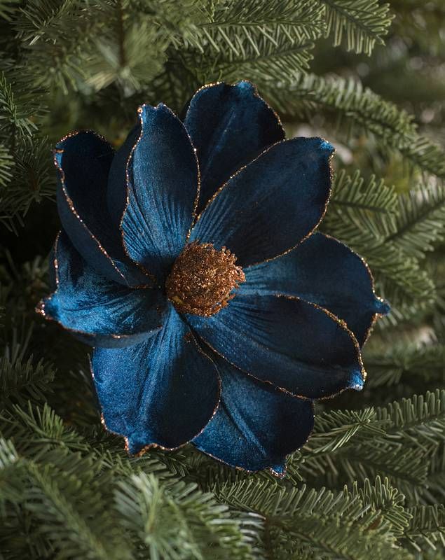 a blue flower sitting on top of a tree