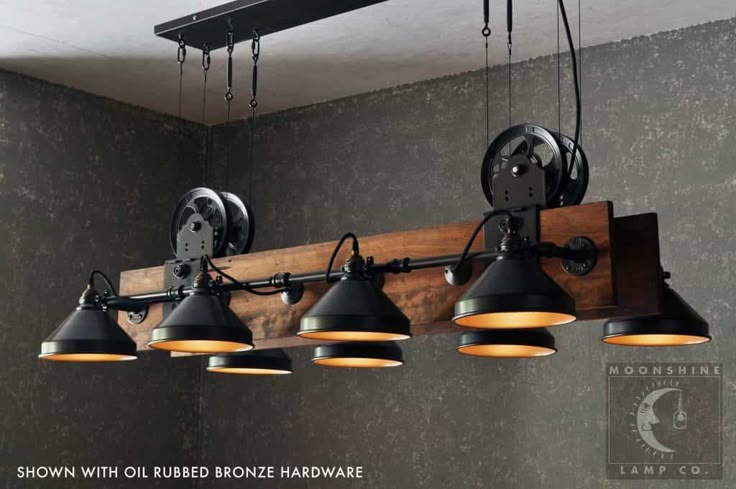 an industrial style light fixture with five lights hanging from it's sides and two on the wall