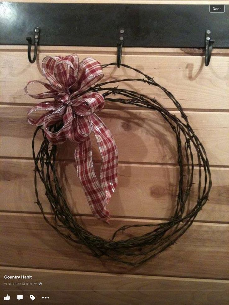 a close up of a wreath on a wall with a ribbon hanging from it's side