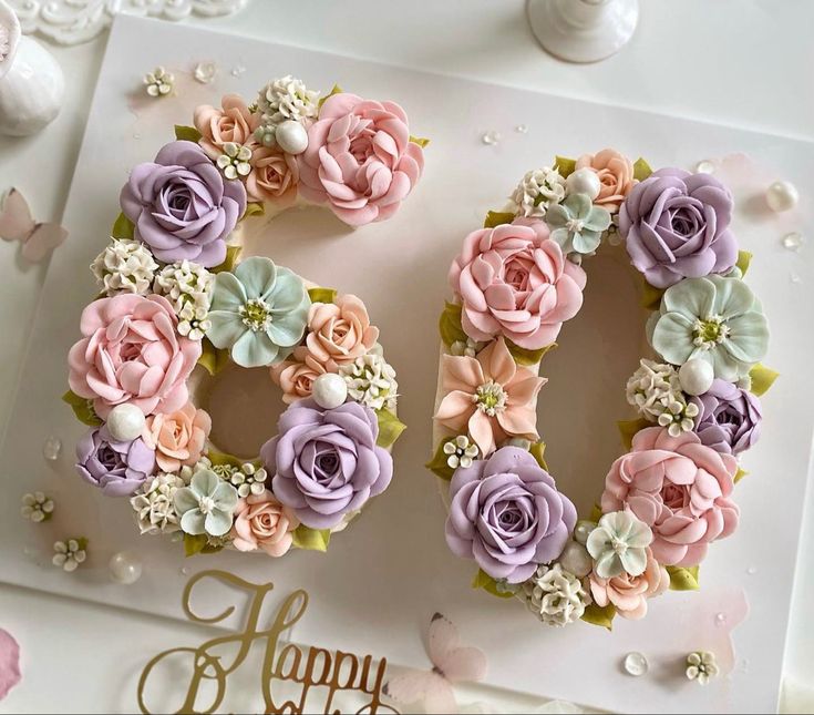 a happy 90th birthday card with pink and purple flowers in the shape of an o