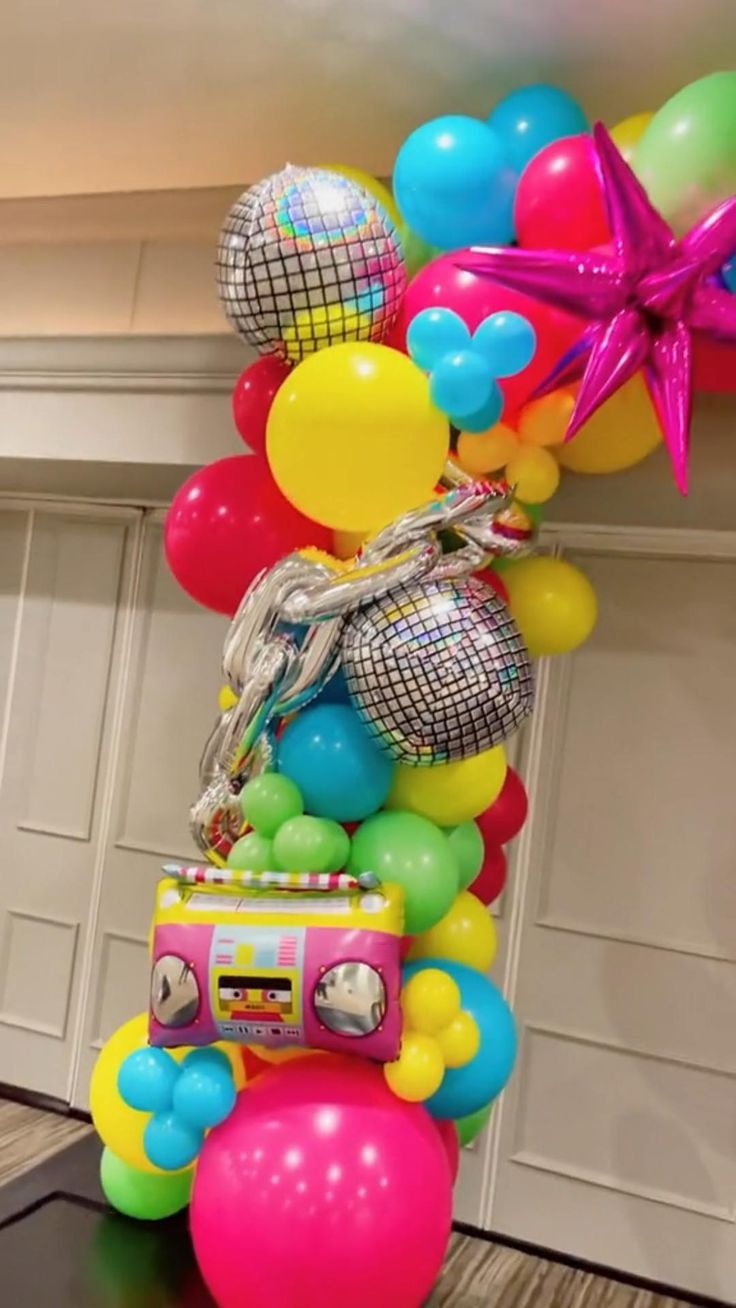 a bunch of balloons that are in the shape of a boombox and some disco balls