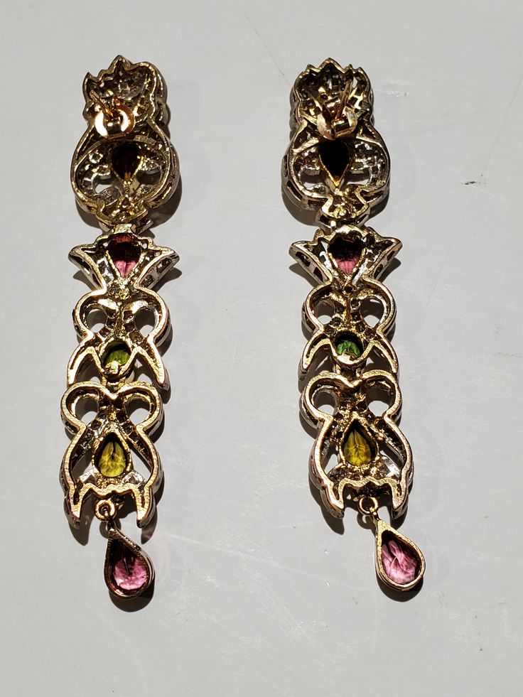 "You are viewing a beautiful set of Vintage 14k solid gold & sterling silver multicolored tourmaline stones and diamond necklace and earrings set. The earrings measures approx.2 7/8 inches long x 5 /8 inches wide. The earrings total weight is approx.20.79 grams. The diamond total weight approx. 1.50ctw While the multicolored tourmaline stones is 3.02 ctw. This earrings is tested 14k yellow and white gold. The earrings is very unique and the diamond are sparkly its merge with all the differen Fine Sterling Silver Jeweled Jewelry, Fine Sterling Silver Jewelry, Fine Jewelry Sterling Silver Jeweled, Formal Multicolor Gemstone Accented Jewelry, Formal Multicolor Gemstone Jewelry, Victorian Jeweled Evening Jewelry, Formal Jeweled Costume Jewelry Sets, Formal Costume Jewelry Sets With Jewels, Ornate Jeweled Jewelry For Evening