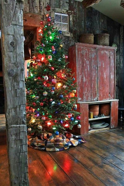 a decorated christmas tree in the corner of a room