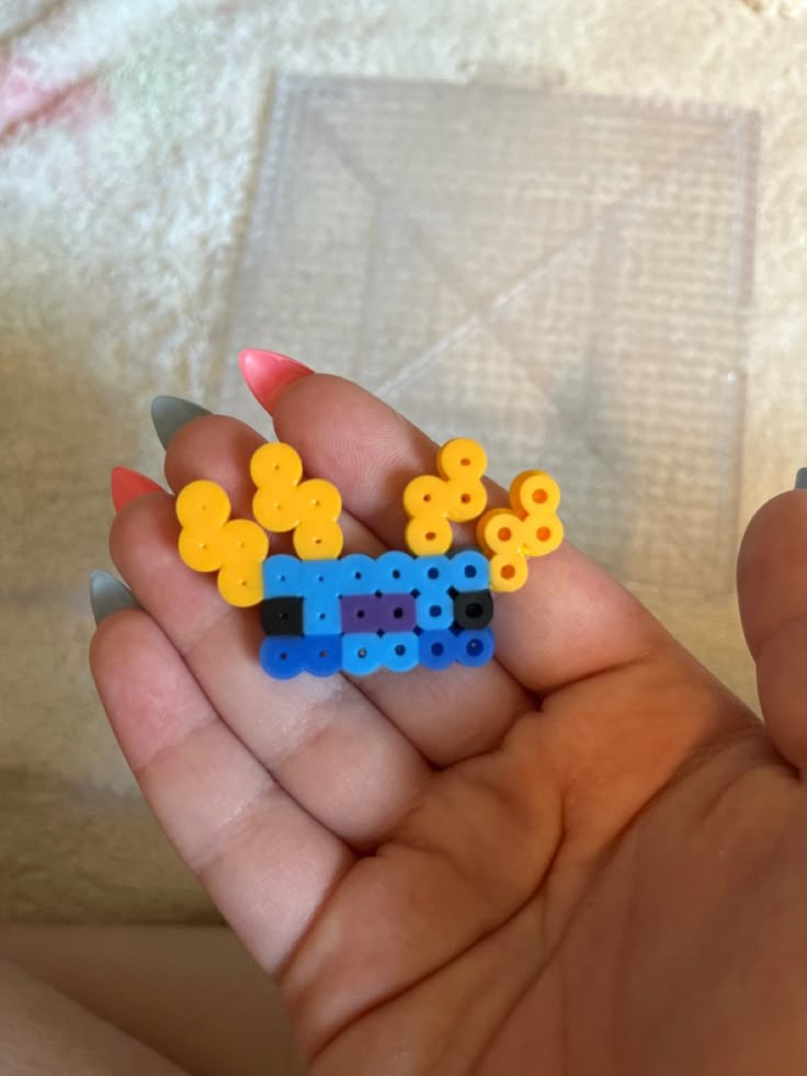 a person holding some small legos in their hand