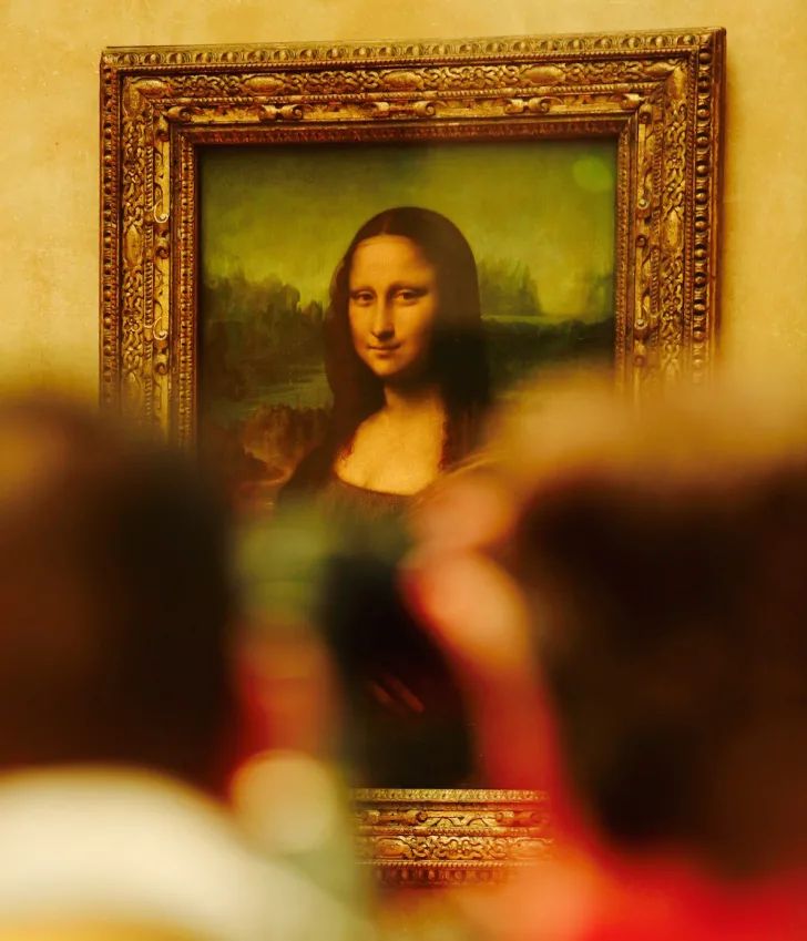 a person taking a photo of a painting