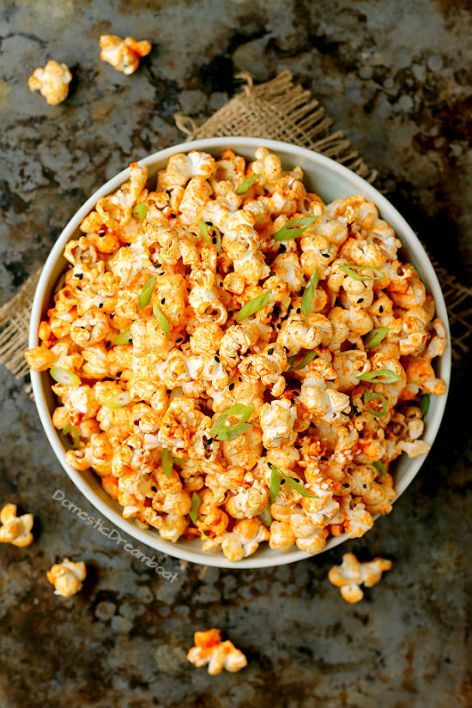 a bowl filled with popcorn on top of a table