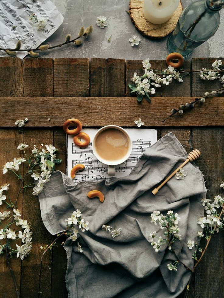 a cup of coffee and some doughnuts on a table