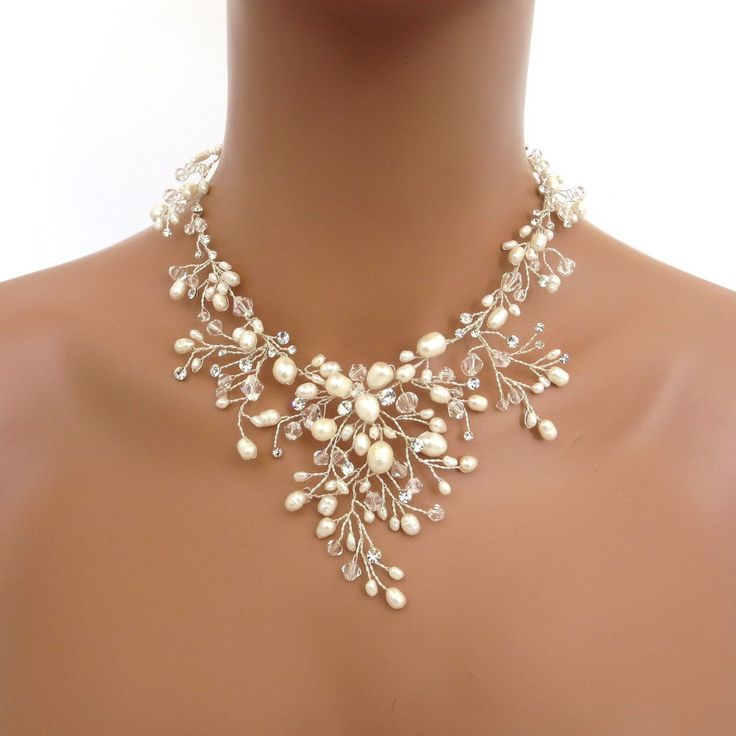 a woman wearing a necklace with pearls on it