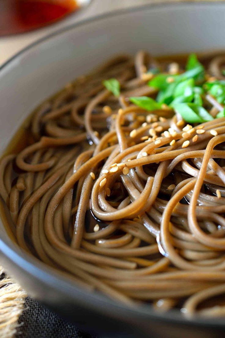 a close up of a bowl of food with noodles