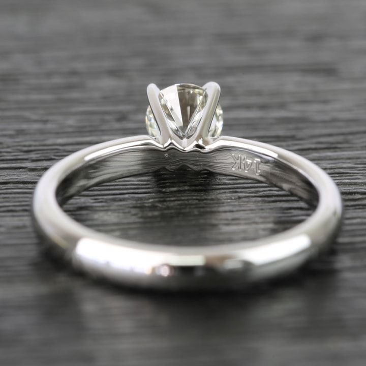 a close up view of a diamond ring on a table