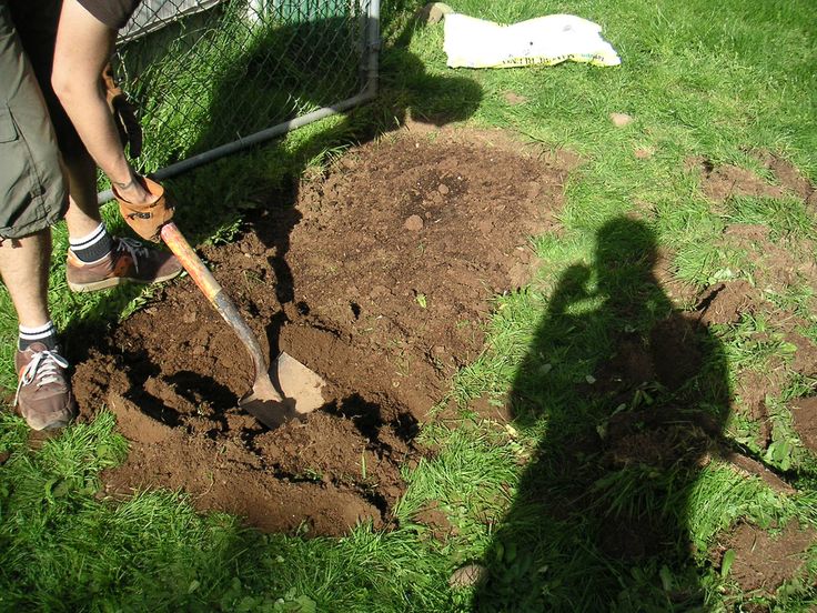 a man is digging in the ground with a shovel