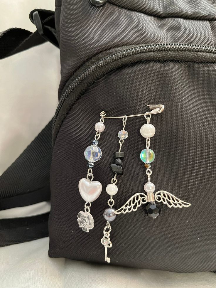 a backpack with some charms attached to it