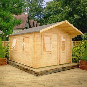 a small wooden building sitting on top of a wooden deck