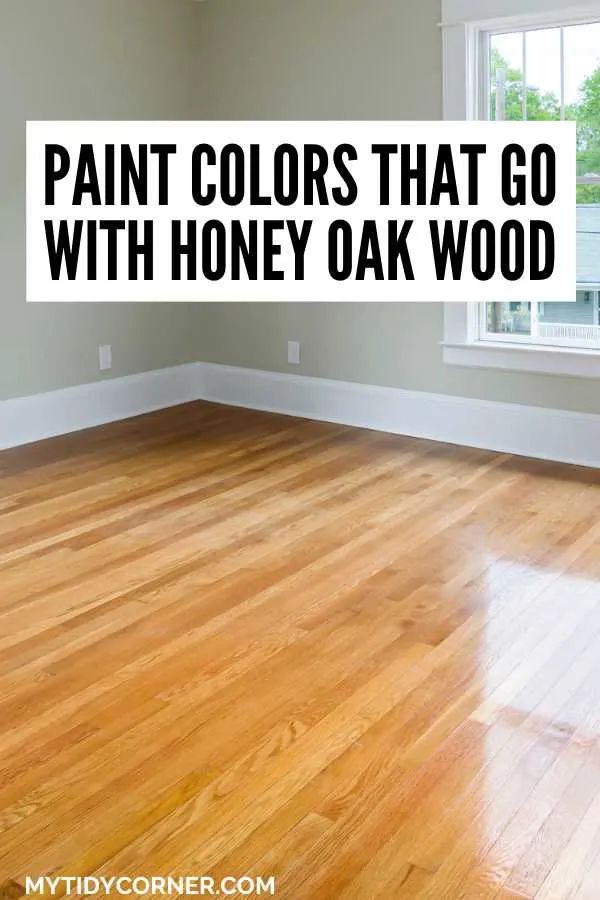 an empty room with hard wood floors and paint colors that go with honey oak wood