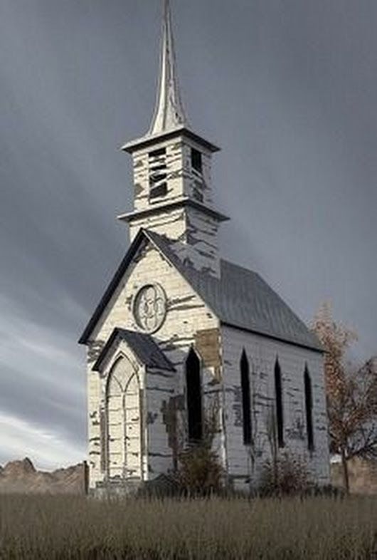 an old white church with a steeple and clock on it's side in the middle of nowhere