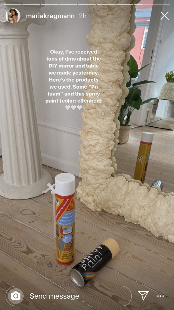 a tube of glue sitting on top of a wooden floor next to a white pillar