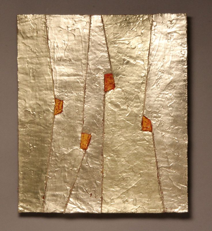 a piece of tin foil with orange squares on it and some brown sticks sticking out of it