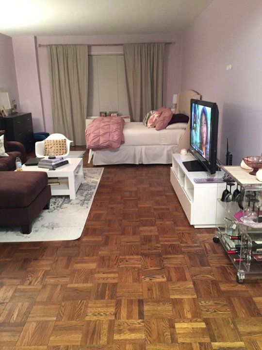 a living room filled with furniture and a flat screen tv sitting on top of a hard wood floor