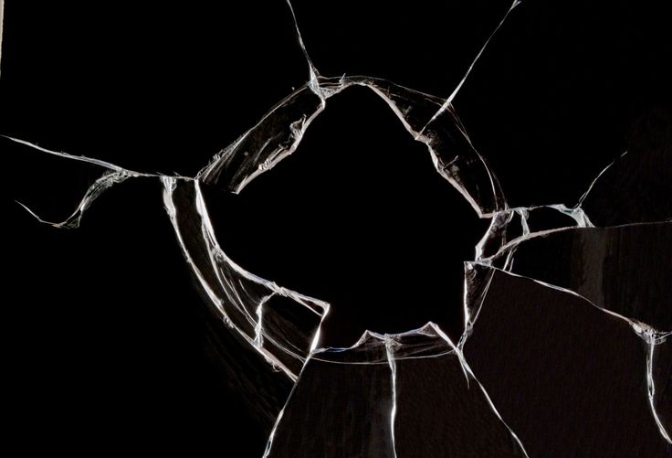 a broken glass window in the dark