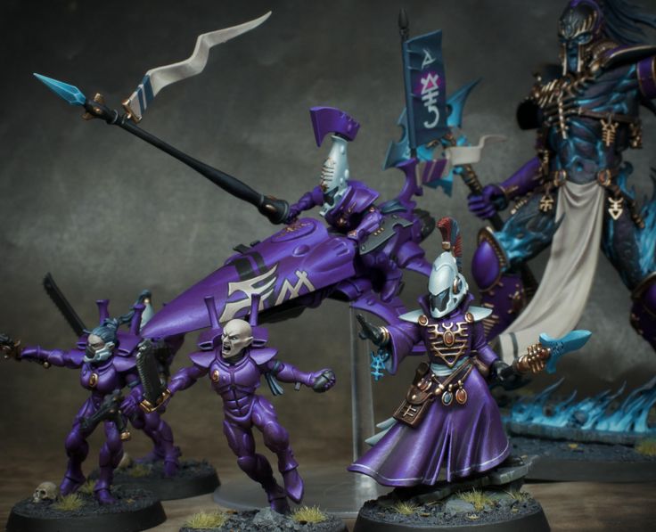 some purple and blue painted warhammers with swords