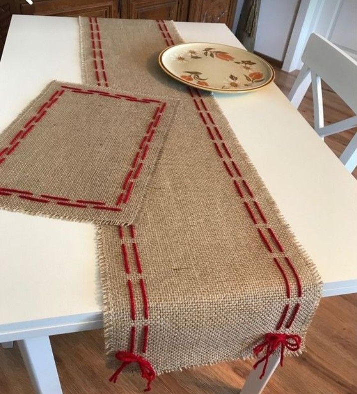 a white table with a red border on it and a plate sitting on top of it