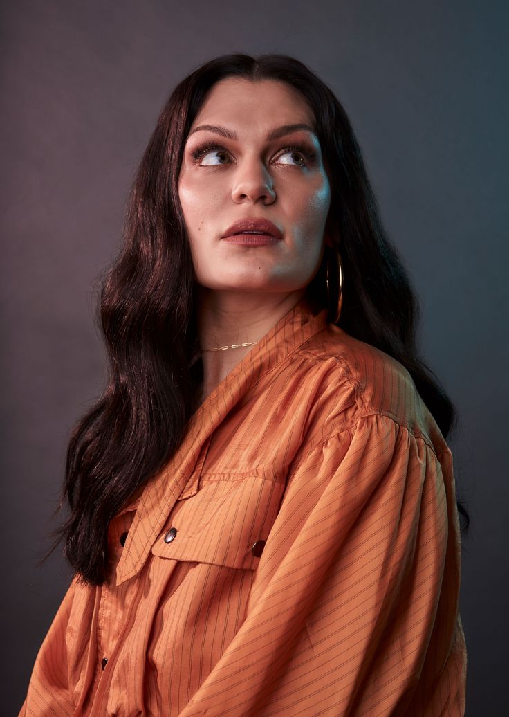 a woman in an orange shirt looking up