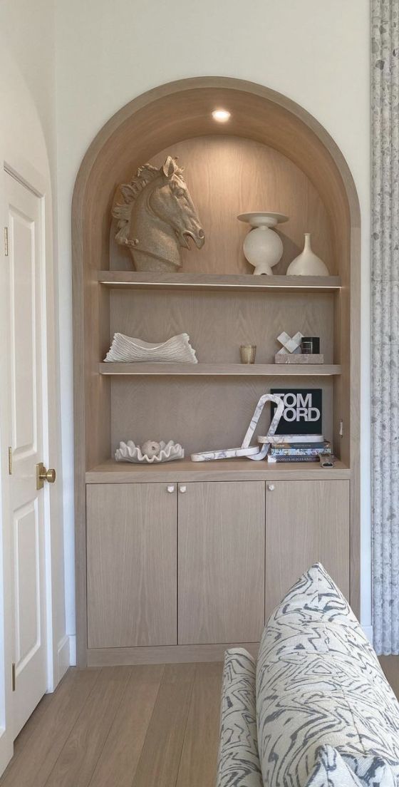 a living room filled with furniture and shelves