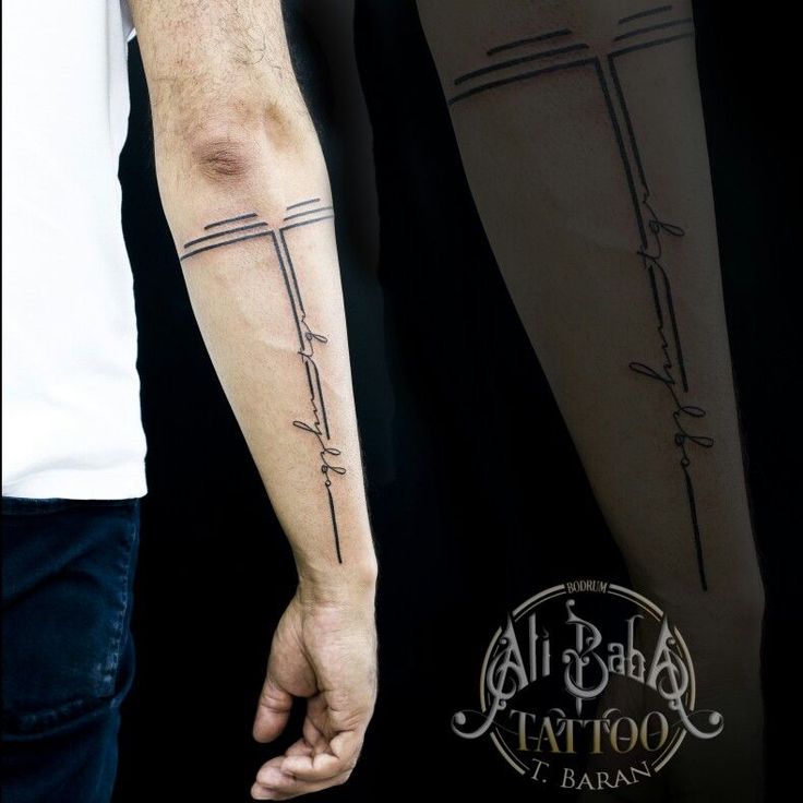 two people holding hands with cross tattoos on their arm and forearms, both in black ink