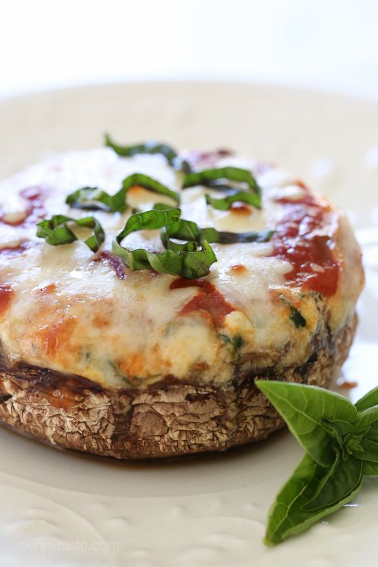 a close up of a plate of food with cheese and spinach on the side