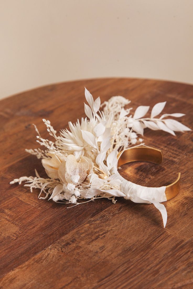 a bouquet of flowers sitting on top of a wooden table next to a pair of scissors