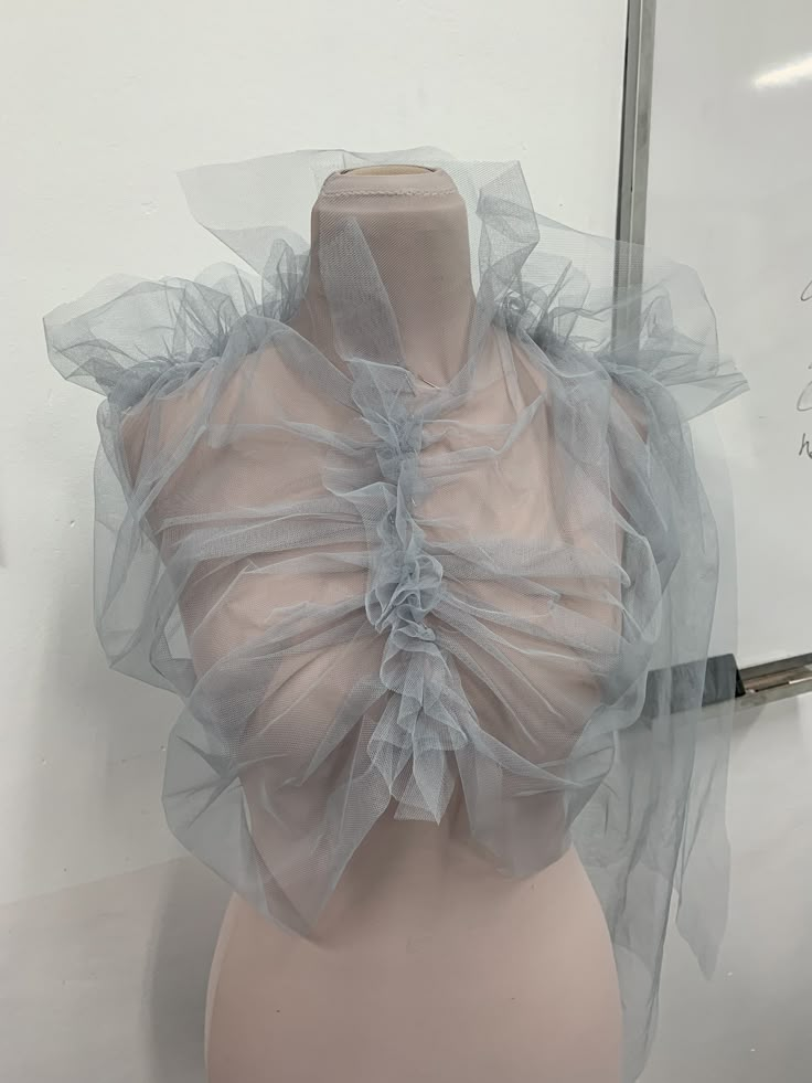 a mannequin's head is covered with sheer fabric