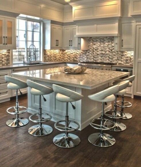 a large kitchen island with four stools in it