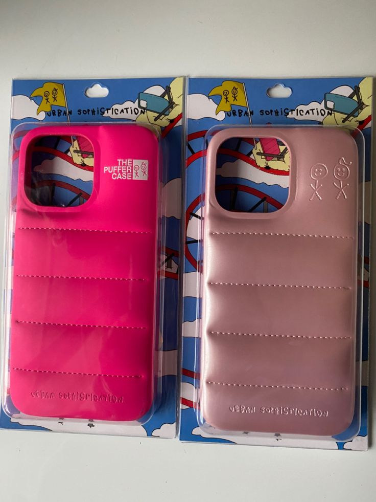 two pink phone cases in packaging on a table