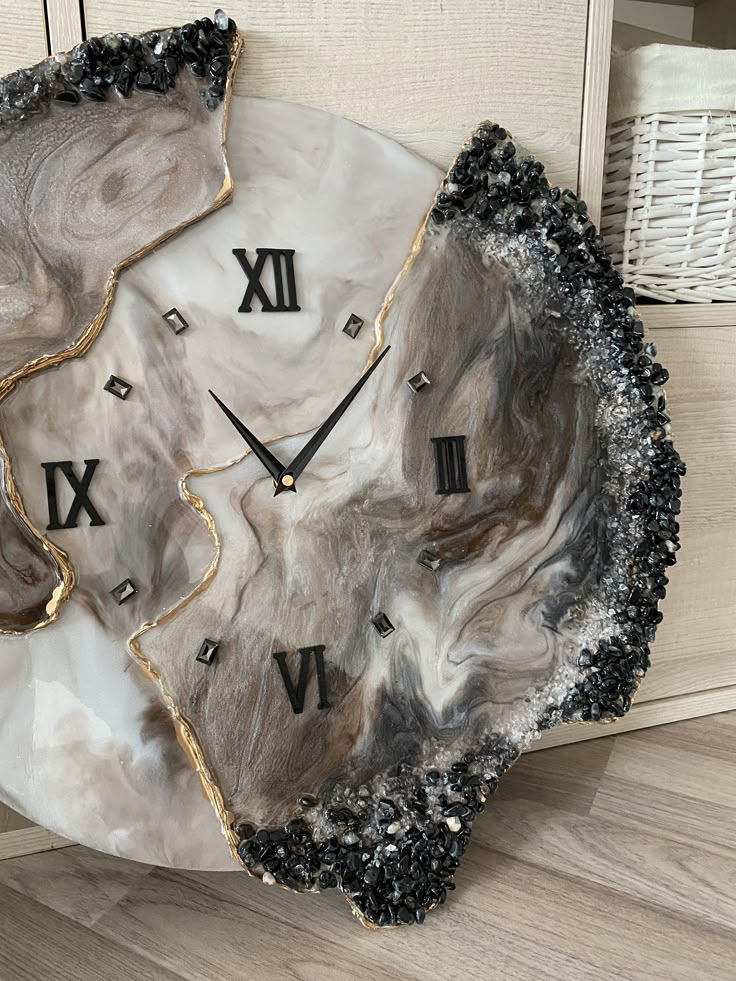 a clock made out of marble with roman numerals