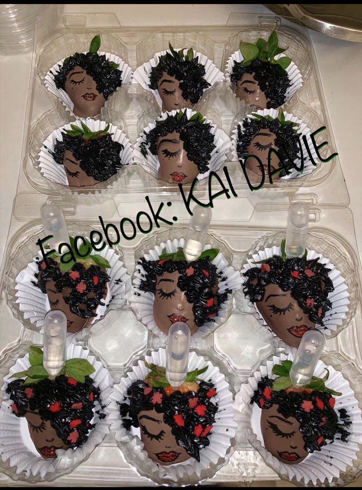 the cupcakes are decorated with black women's faces and flowers on them