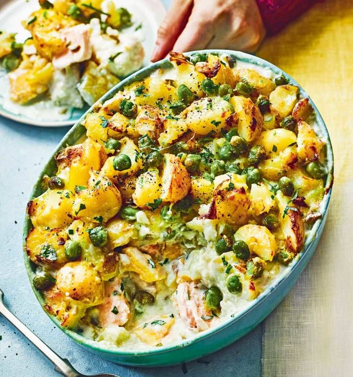 two plates filled with food on top of a blue table next to silver spoons